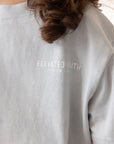 Close-up of the small white Elevated Faith chest lettering on the Open Air Blue Kids Tee