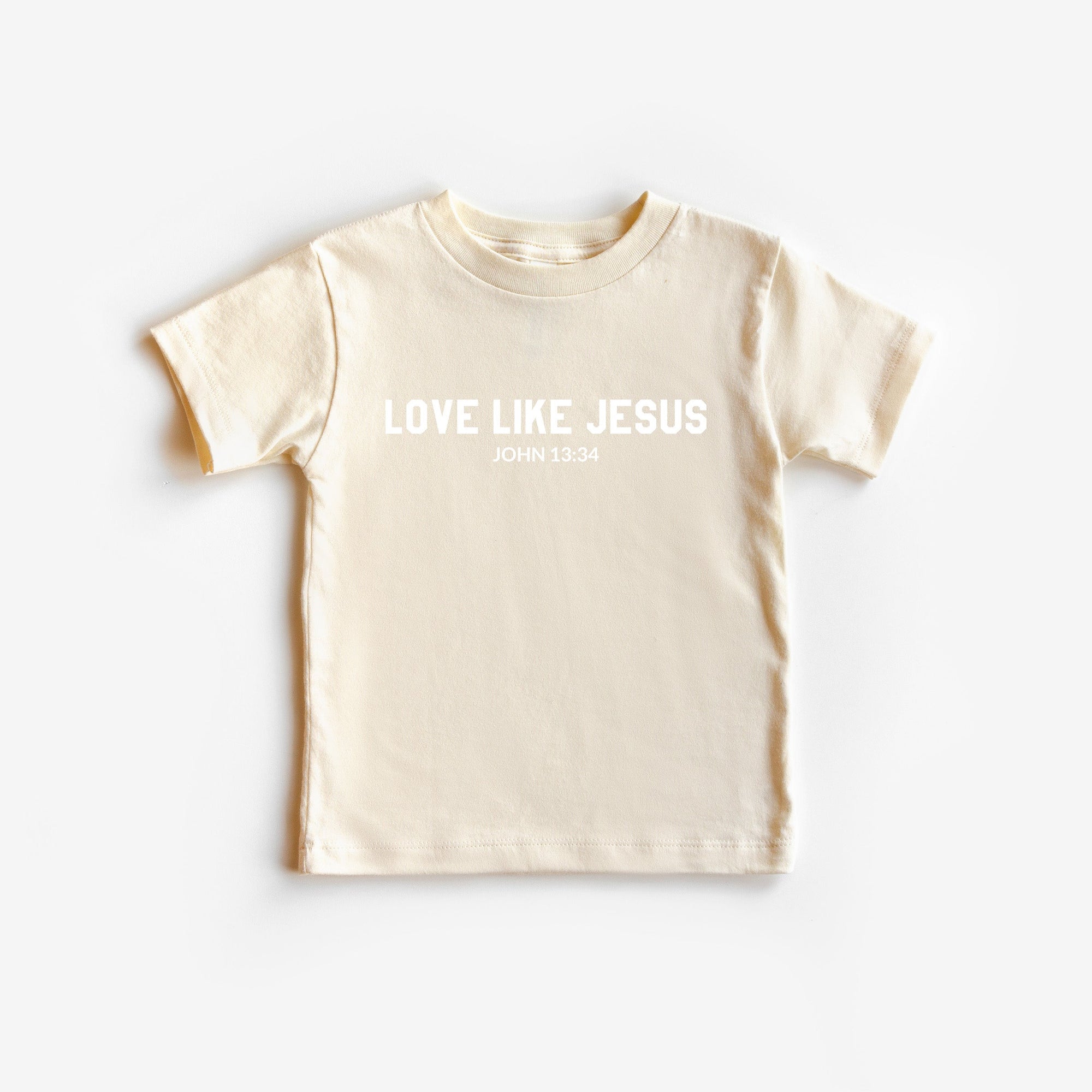 Beige t-shirt with 'Love Like Jesus' text on a white background