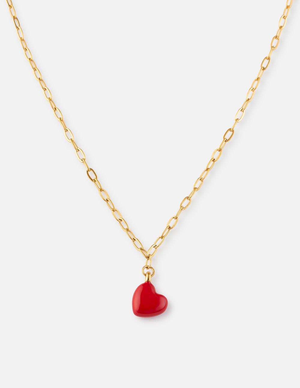 Love necklace featuring a red heart pendant on a gold-tone paperclip chain against a white background