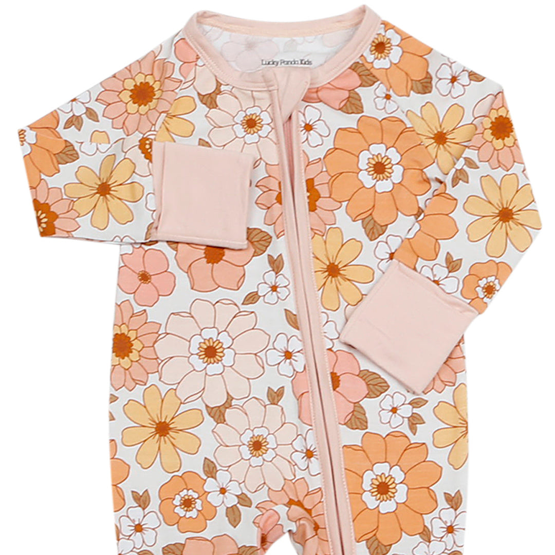 Floral-patterned baby onesie with pink accents on a white background