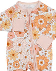 Floral-patterned baby onesie with pink accents on a white background