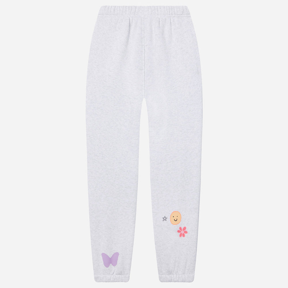 White sweatpants with embroidered designs on a white background