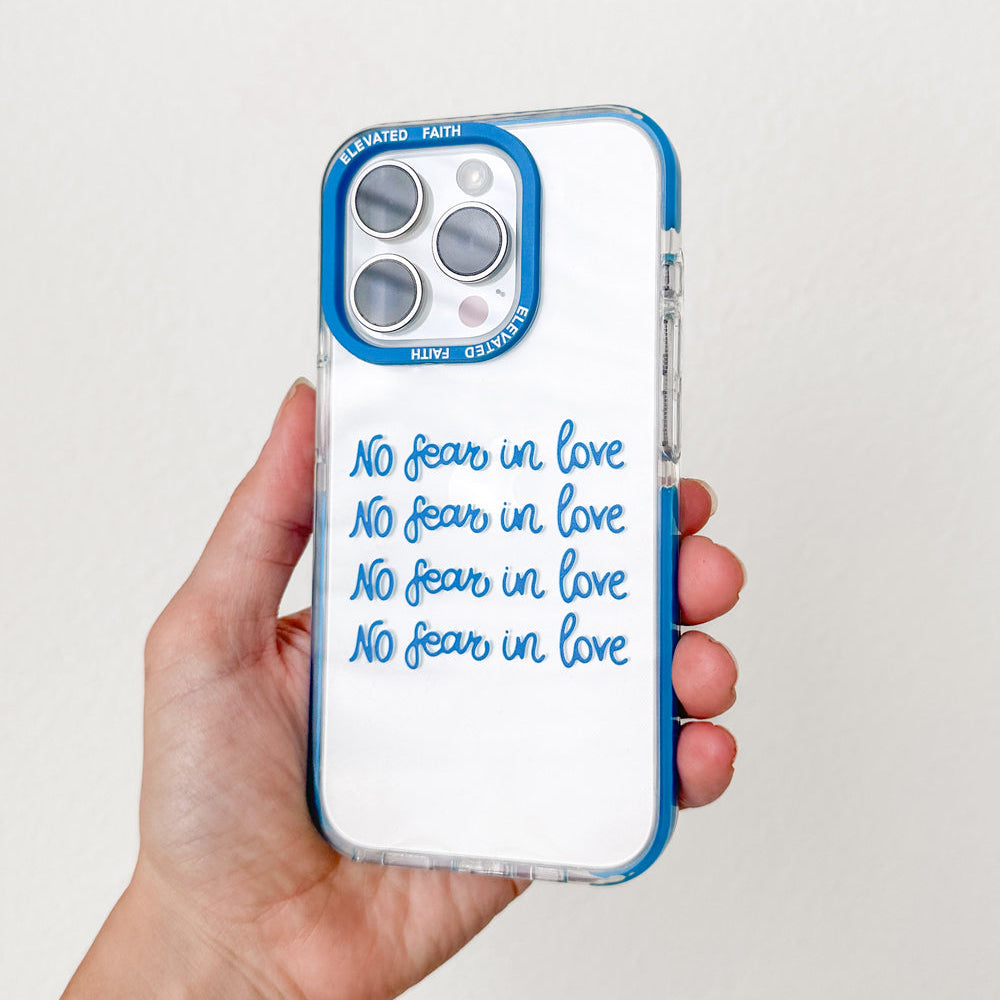 Phone case with 'No fear in love' text held by a hand against a white background