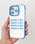 Phone case with 'No fear in love' text held by a hand against a white background