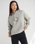 Front view of the Not of This World Hoodie showing a small circular chest graphic.