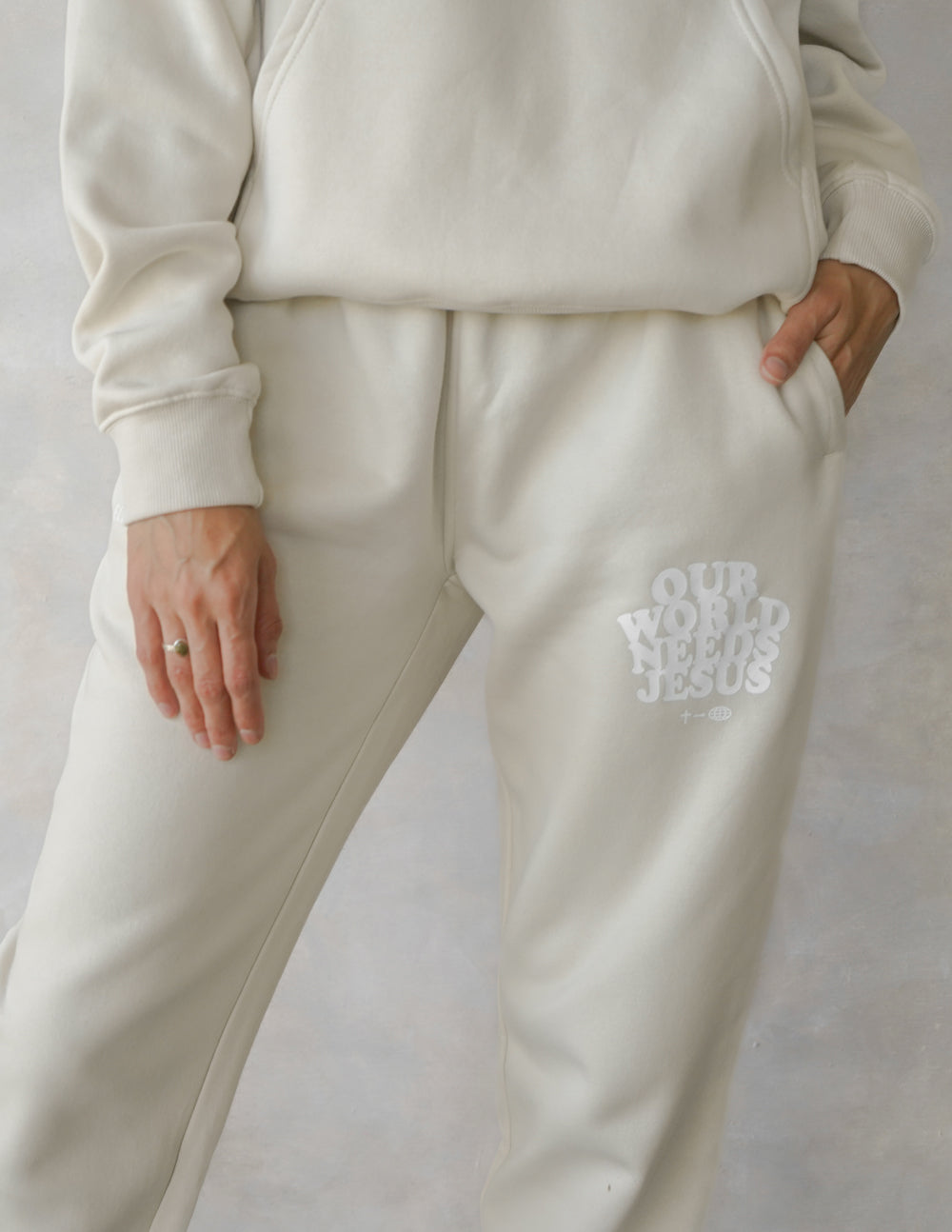 Our World Needs Jesus Beige Unisex Sweatpants