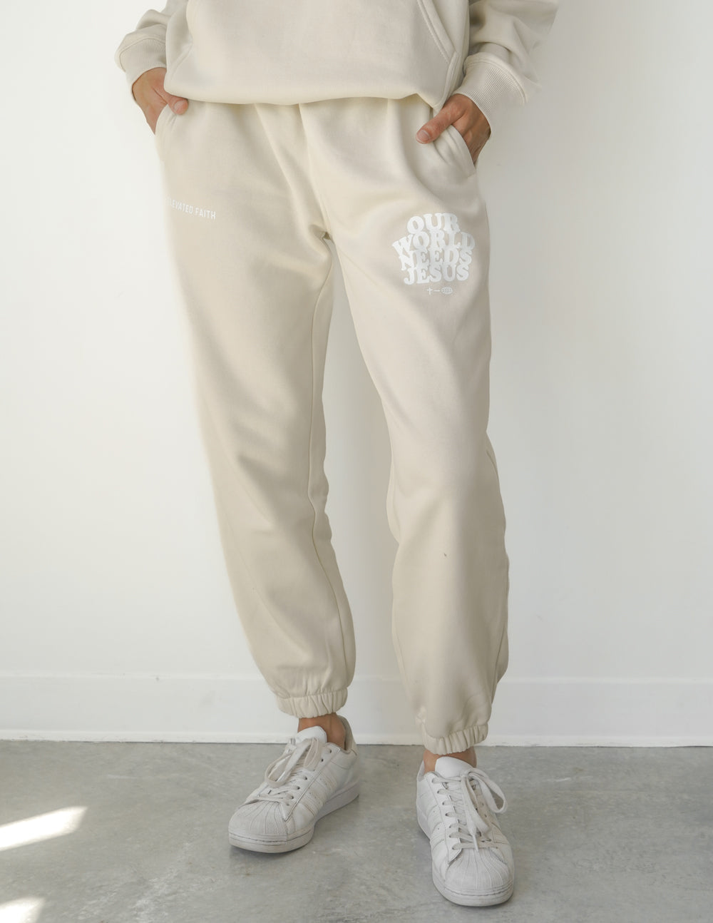 Our World Needs Jesus Beige Unisex Sweatpants