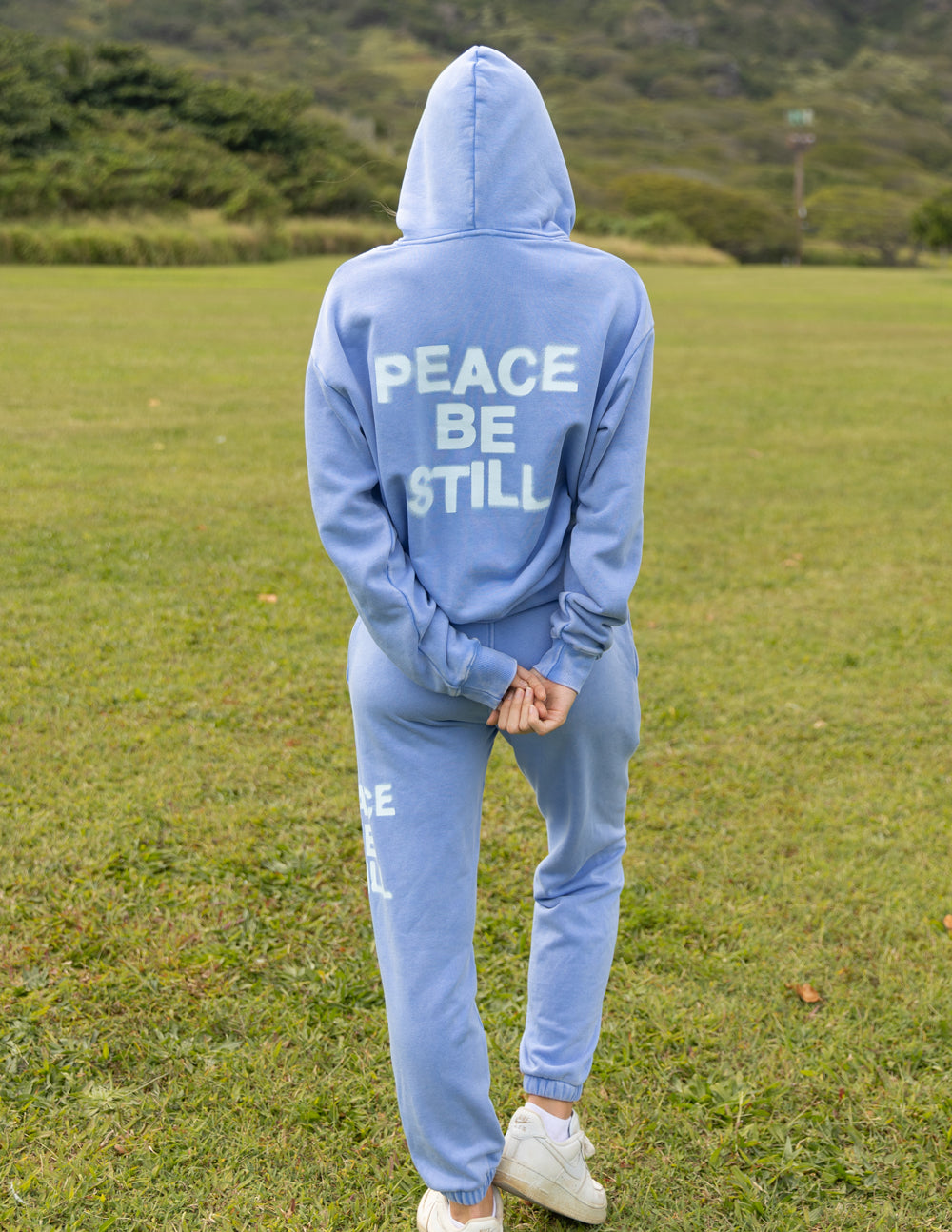 Full-length back view of the Mountain Bluebird hoodie styled with coordinating blue sweatpants.