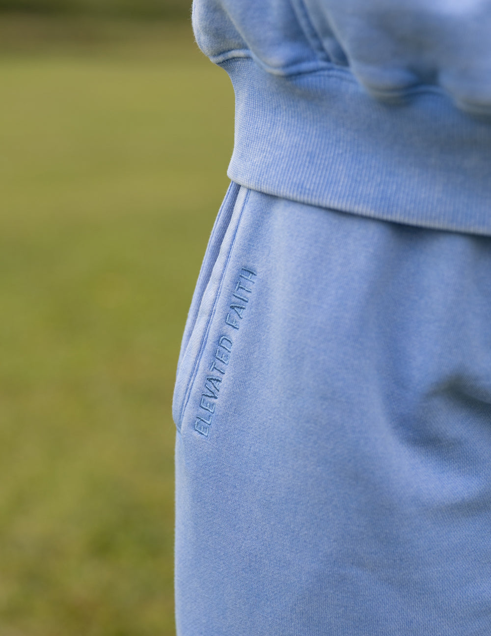 Close-up of the Mountain Bluebird sweatpants showing the side pocket and garment-dyed fabric.