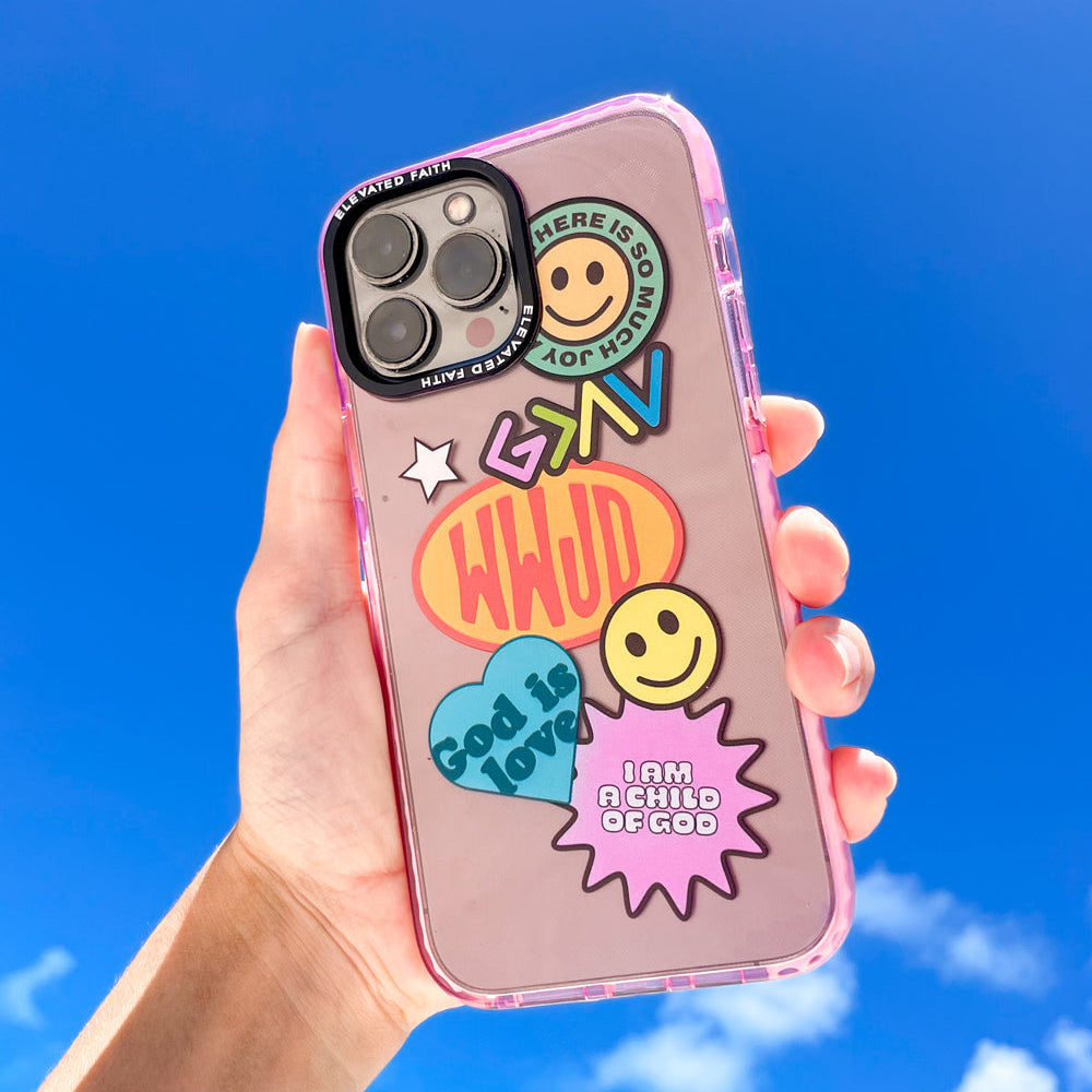 Phone case with colorful designs and text held against a blue sky