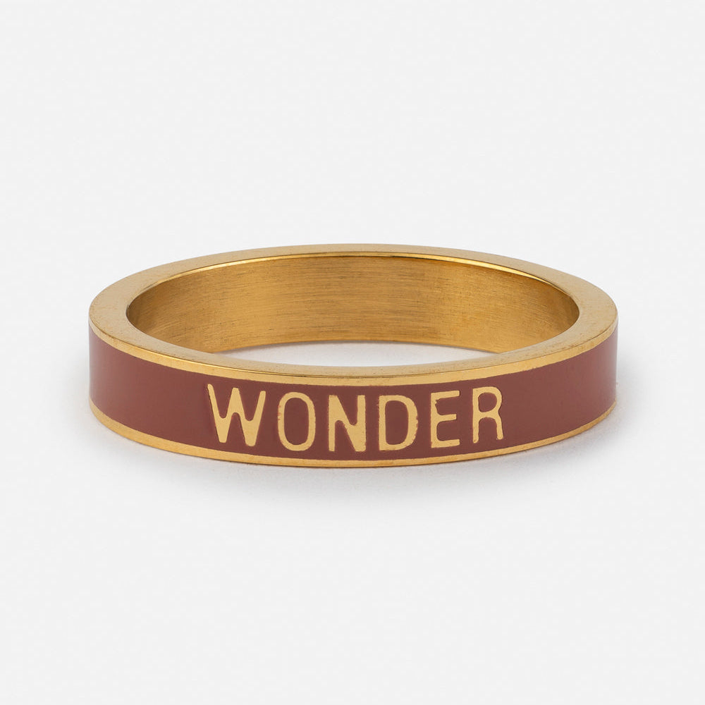 Gold and red bracelet with 'WONDER' text on a white background