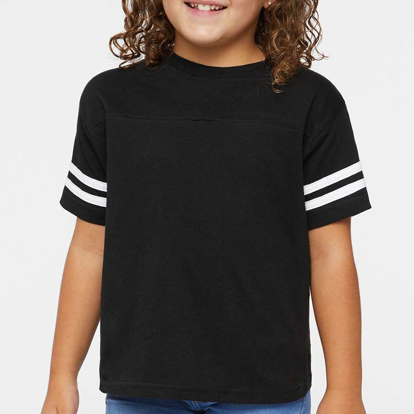 Young girl wearing a black t-shirt with white stripes on a plain background