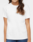 Young girl wearing a plain white t-shirt against a white background