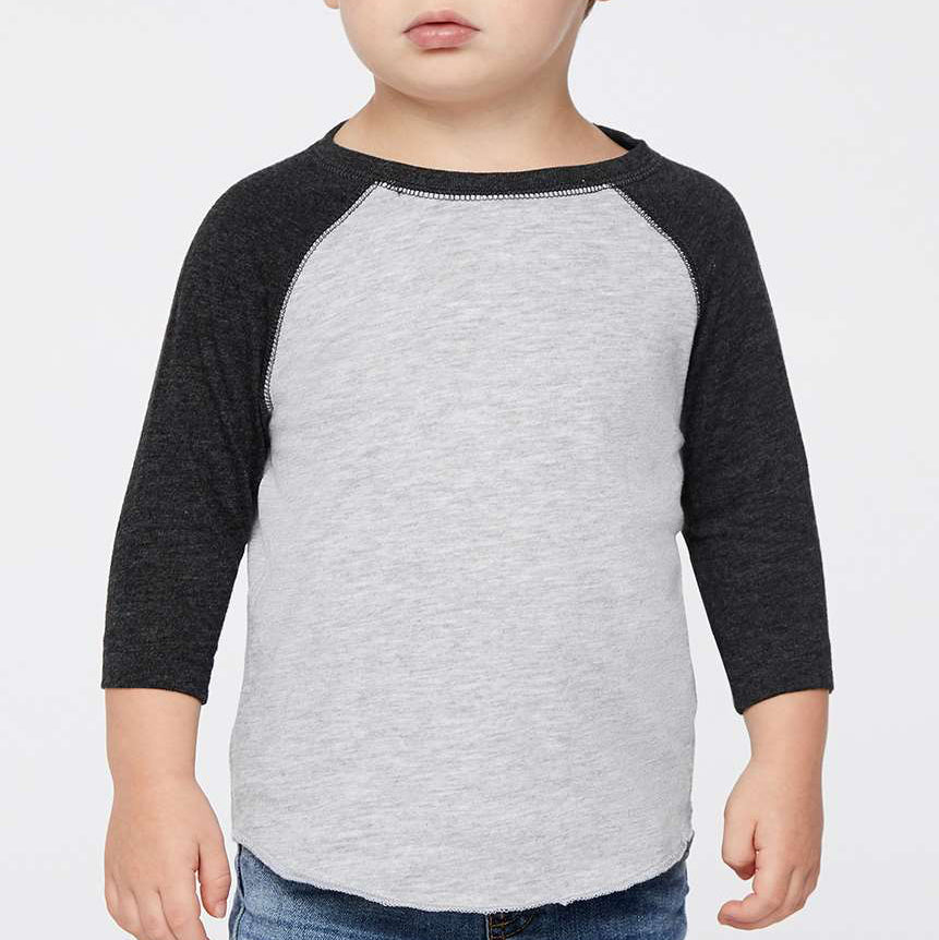 Child wearing a gray and black baseball shirt on a white background
