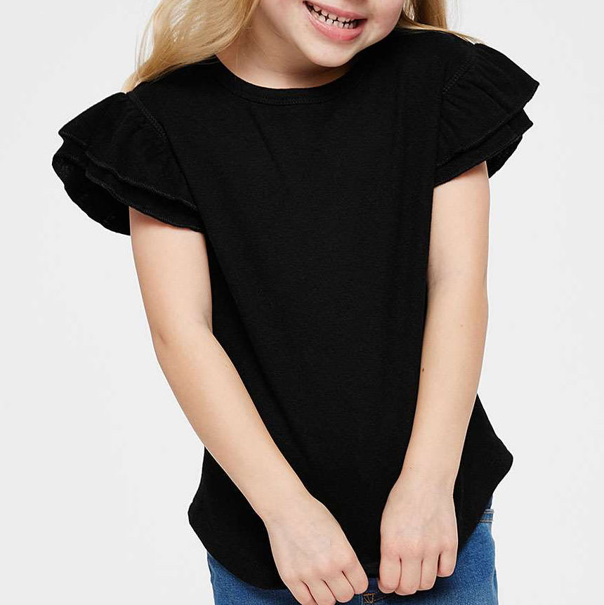 Young girl wearing a black ruffled blouse against a white background