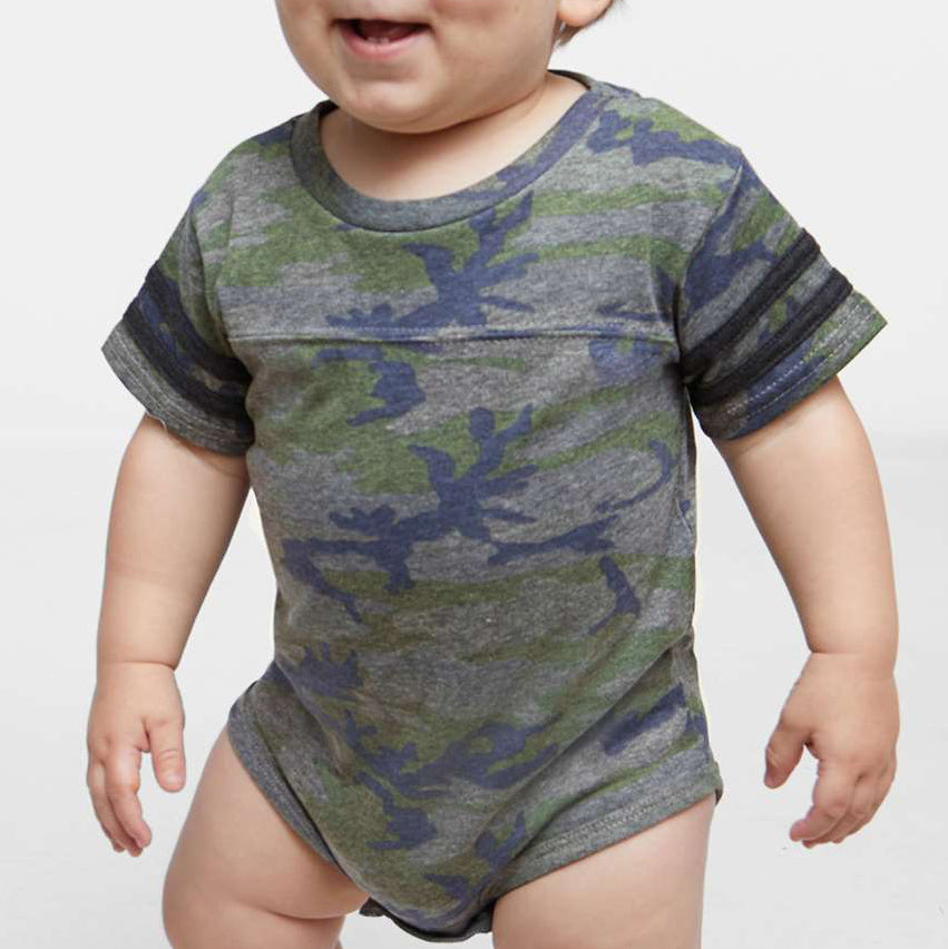Baby wearing a camouflage onesie on a white background