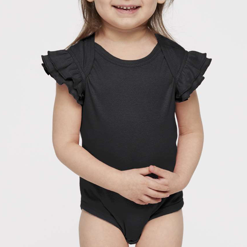 Child wearing a black onesie with ruffled sleeves on a white background