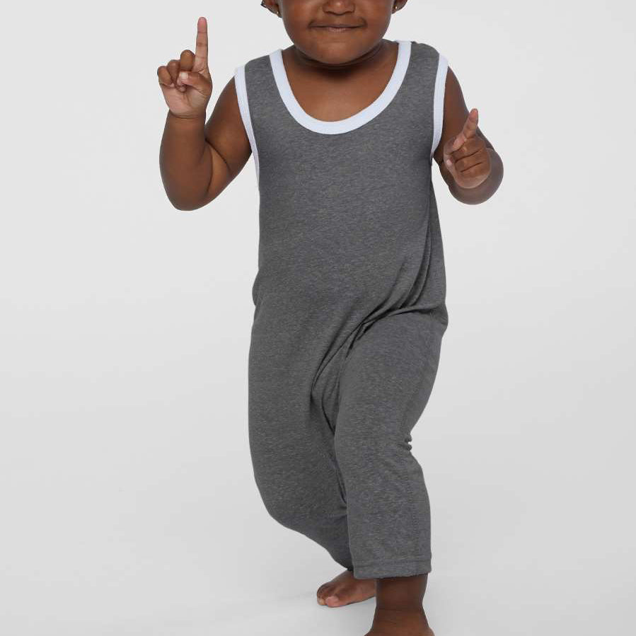 Child wearing a gray sleeveless dress with white trim on a plain background