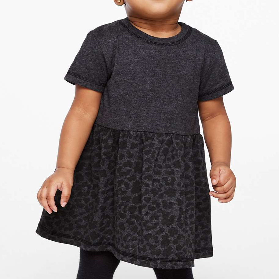 Child wearing a dark gray dress with a leopard print skirt on a white background