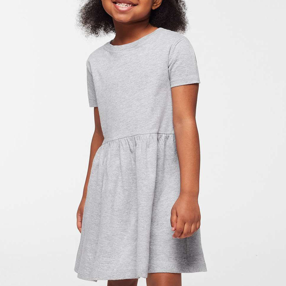 Young girl wearing a gray dress on a white background