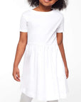 Young girl wearing a white dress on a white background
