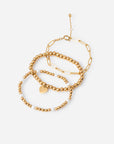 Renewal three-piece gold-tone bracelet set with beaded designs, a paperclip chain, and a heart charm