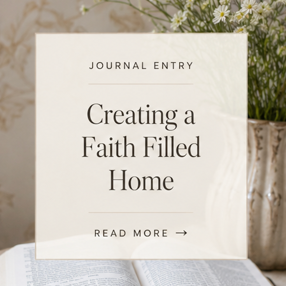 Open book with a white card overlay titled 'Creating a Faith Filled Home' on a wooden surface with flowers in the background.