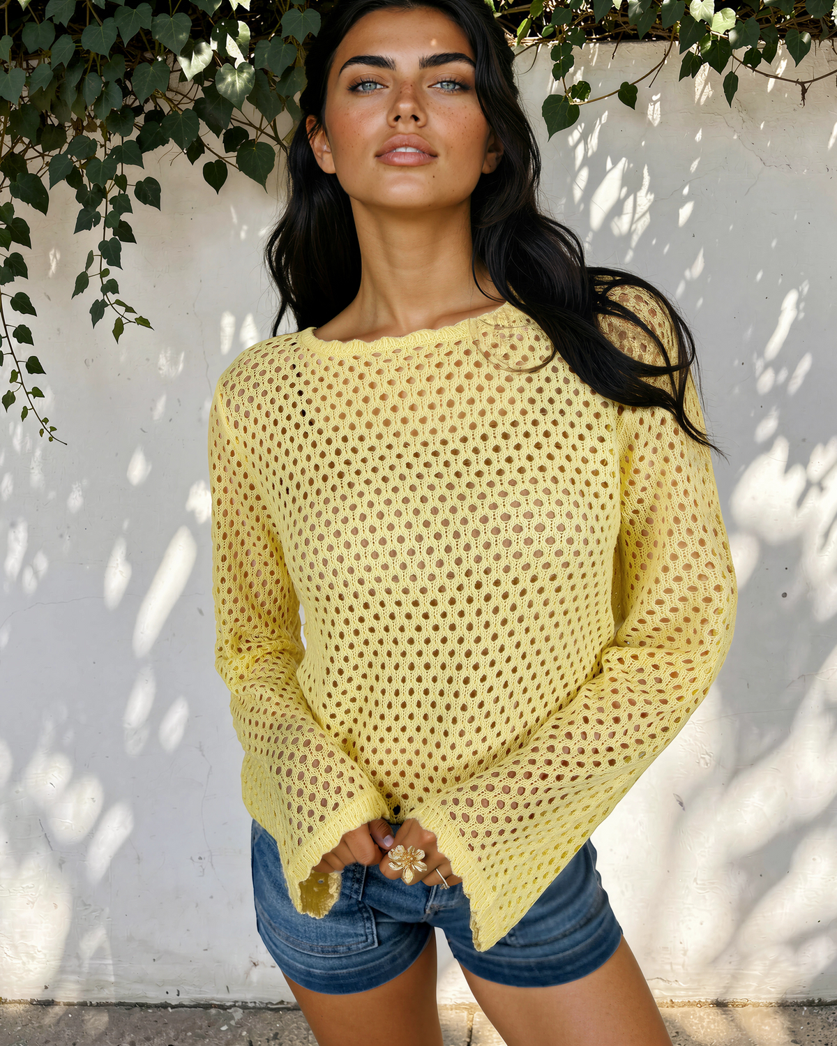 Front view of the yellow Felicity open-knit top with a round neckline, styled with denim shorts.