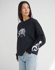 Front view of the Spirit Is Moving heavyweight tee showing white lettering and flowing sleeve graphics