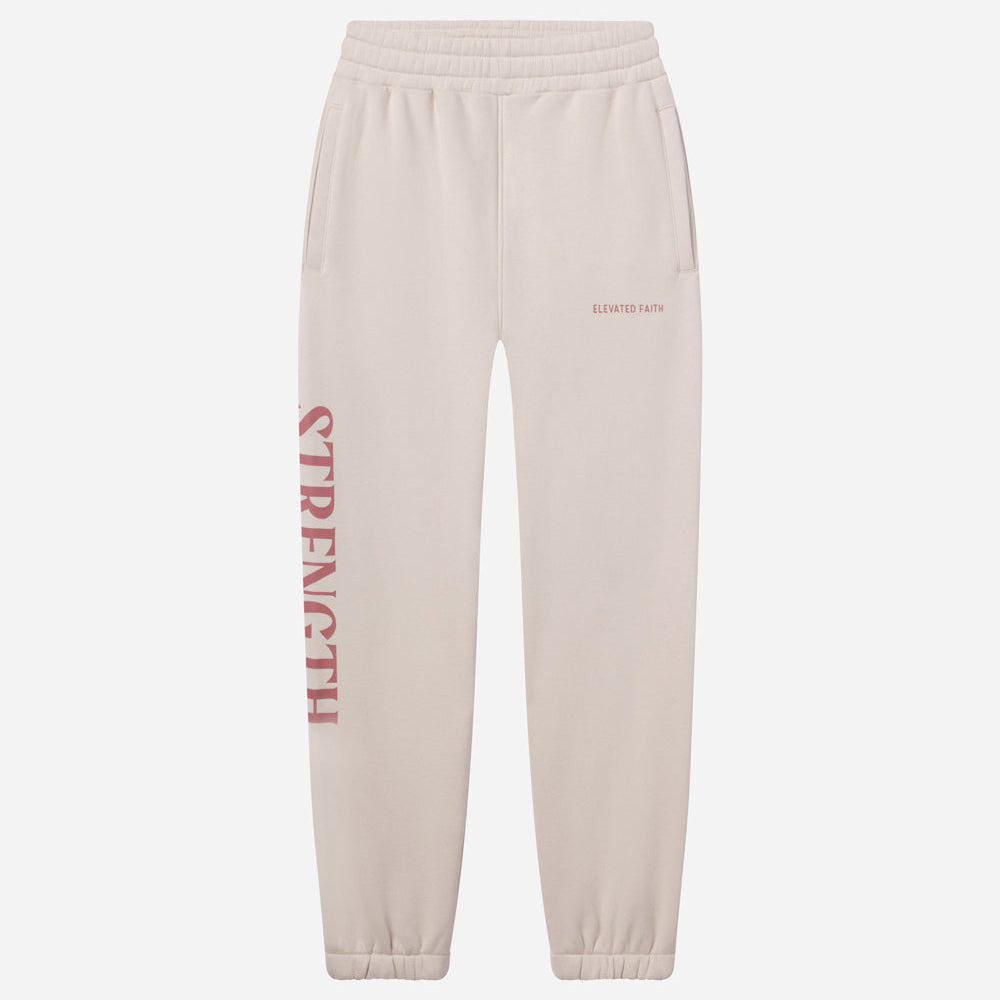 Beige sweatpants with 'STRENGTH' printed in red on a white background