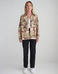 Full-length front view of the What a Friend in Jesus Camo Shacket with black pants and white shoes.