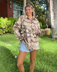 Woman styling the What a Friend in Jesus Camo Shacket with denim shorts outdoors.