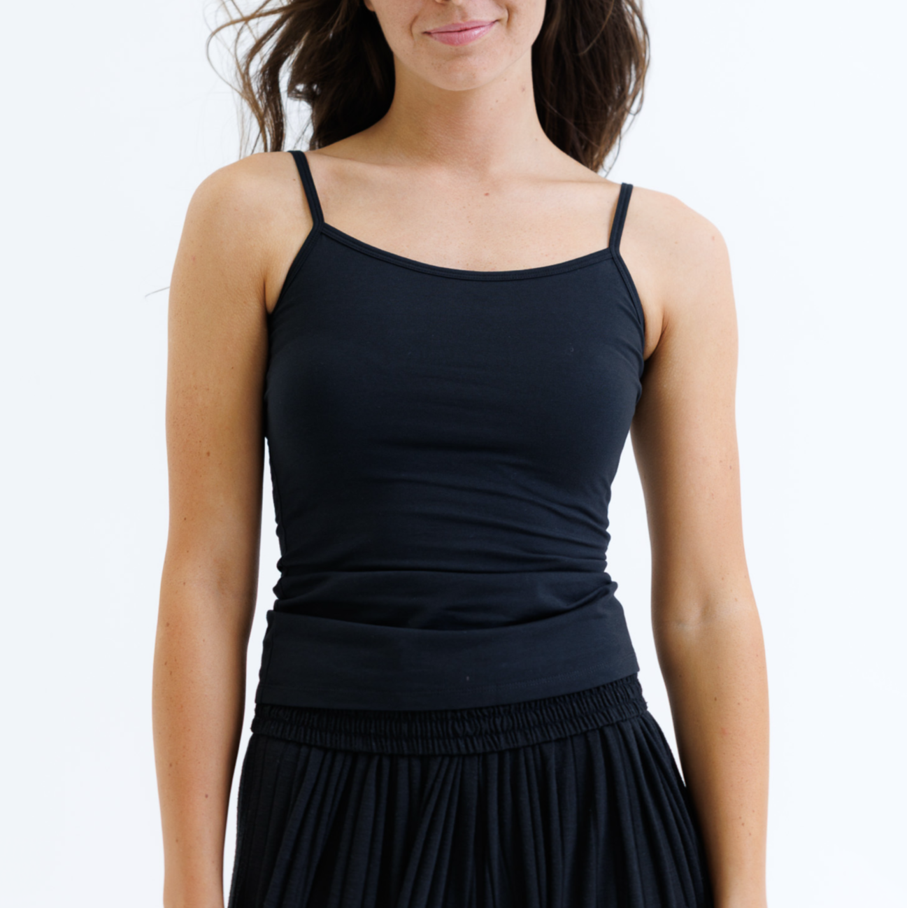 Woman wearing a black dress against a white background