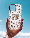 Phone case with 'You are loved by God' text held against a blue sky
