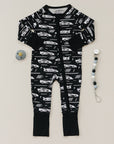 Black baby onesie with car pattern and two安抚teethers on a light gray background