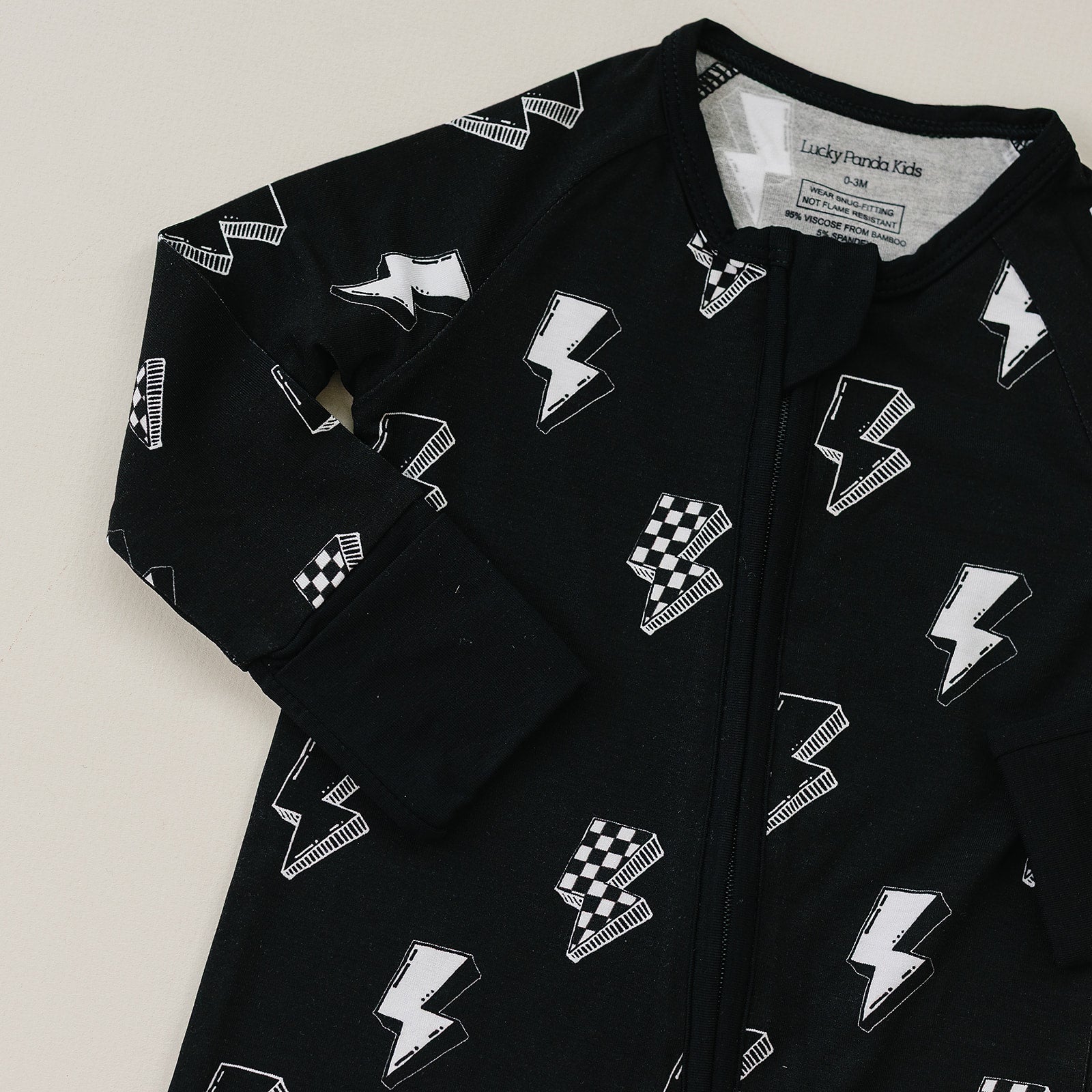 Black onesie with white geometric pattern on a light gray background
