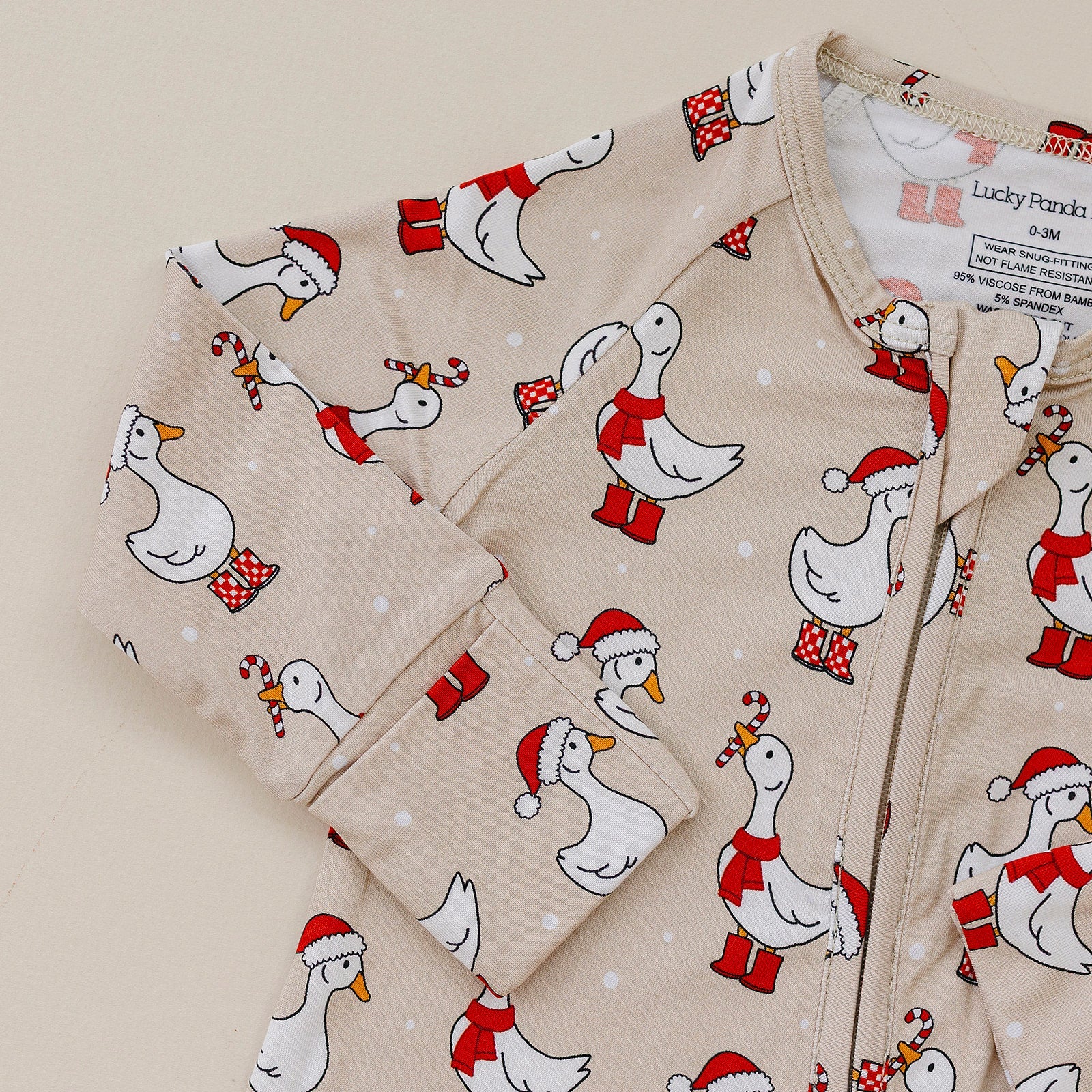 Children's hoodie with Christmas duck pattern on a beige background