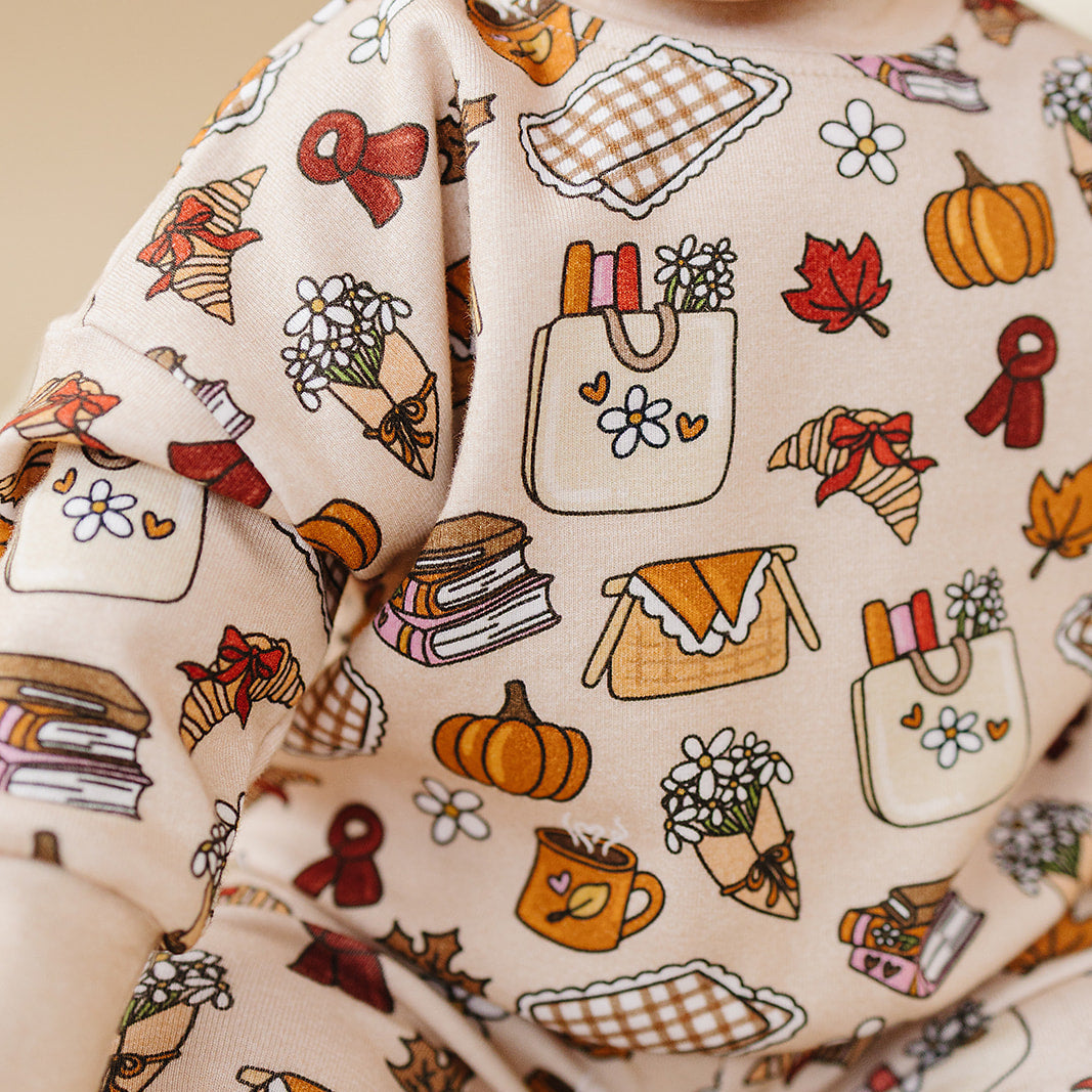 Baby wearing a long-sleeve shirt with autumn-themed pattern