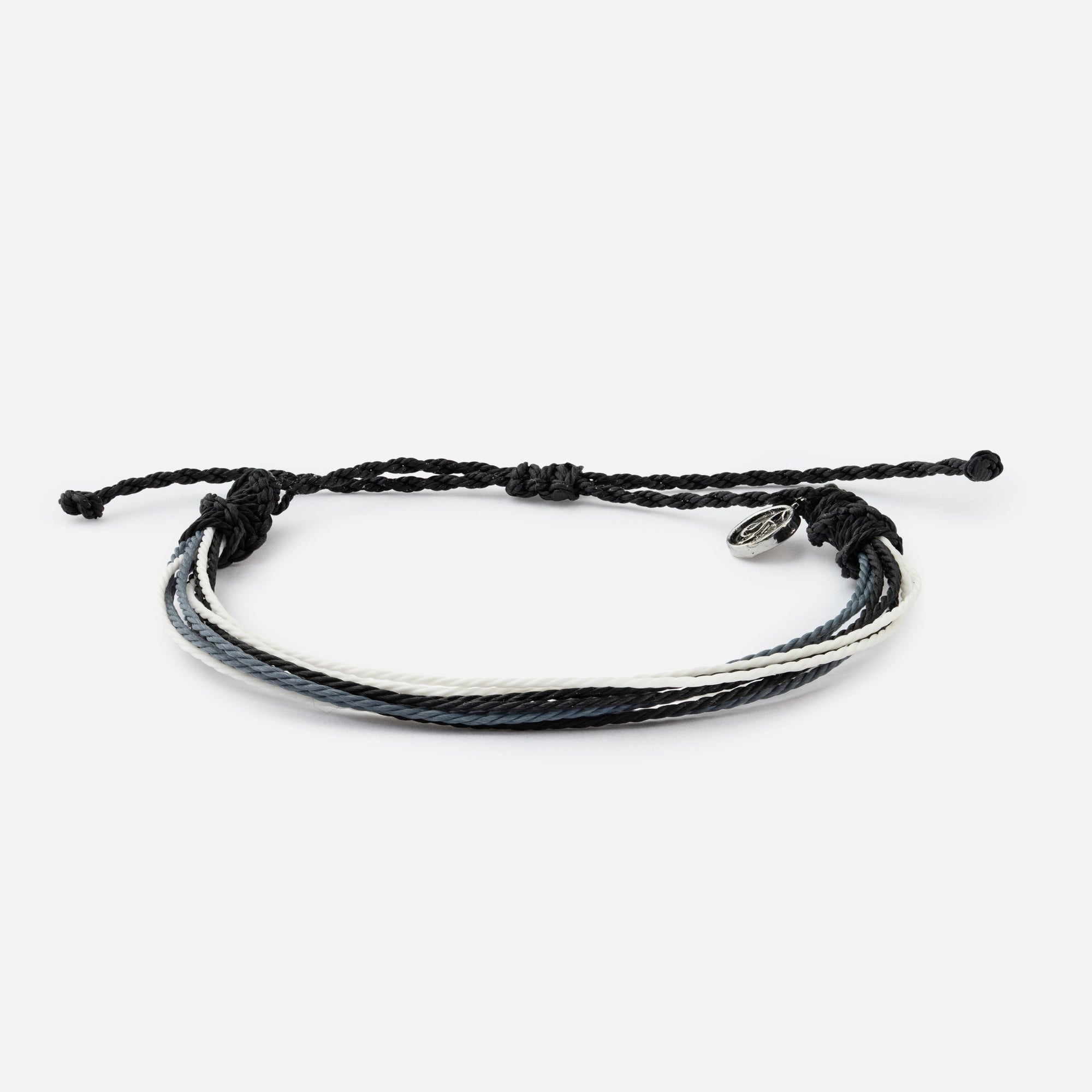 Black braided bracelet with a silver charm on a white background