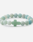 Beaded bracelet with a cross charm on a white background
