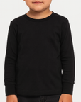 Toddler boy wearing a black BELLA + CANVAS 3501T long sleeve jersey tee, front view, neutral background, ideal for custom printing