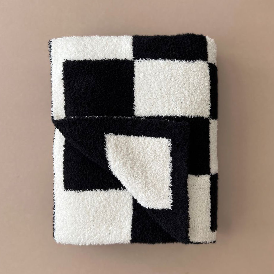 Black and white checkered blanket on a beige background