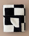 Black and white checkered blanket on a beige background