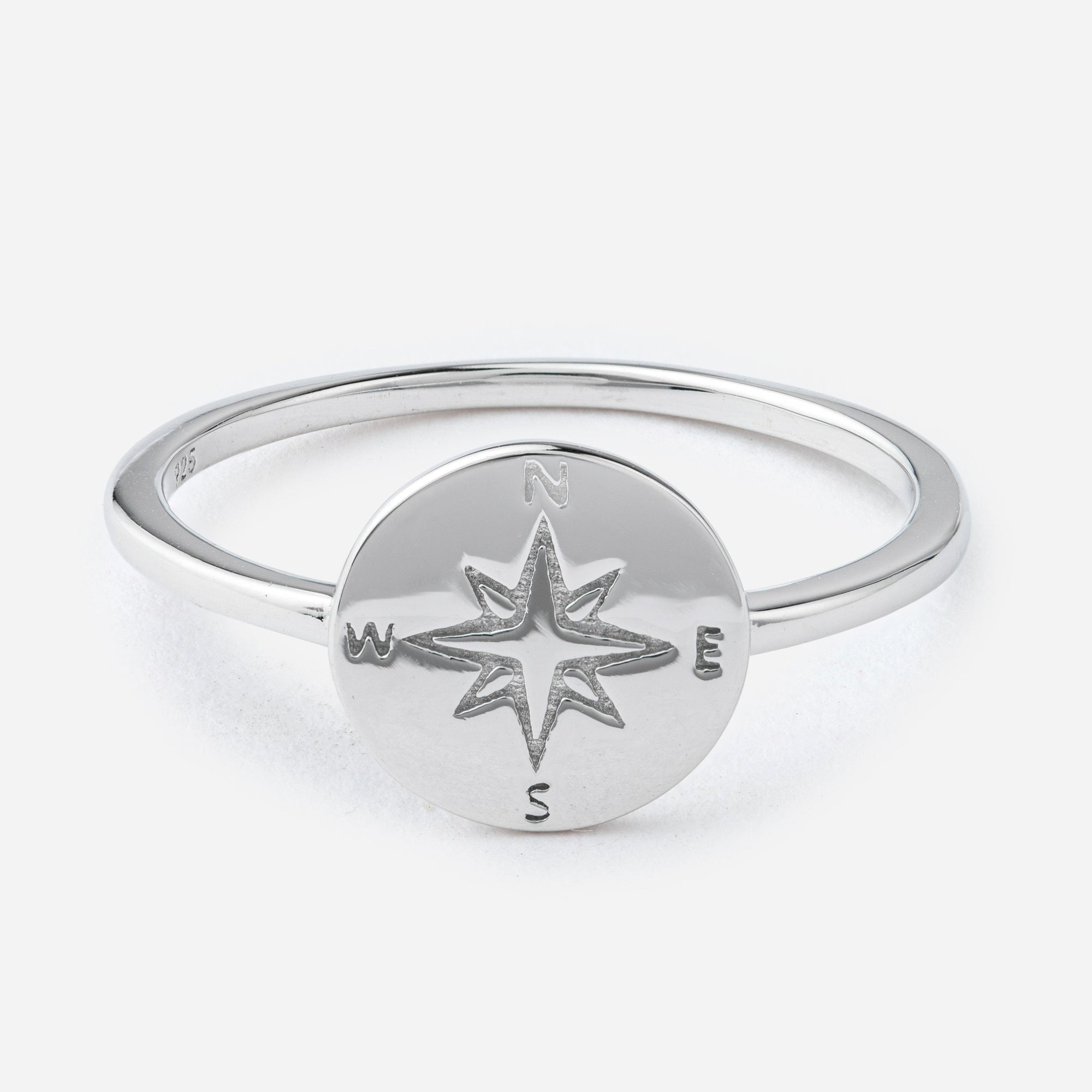 Silver ring with a compass design on a white background