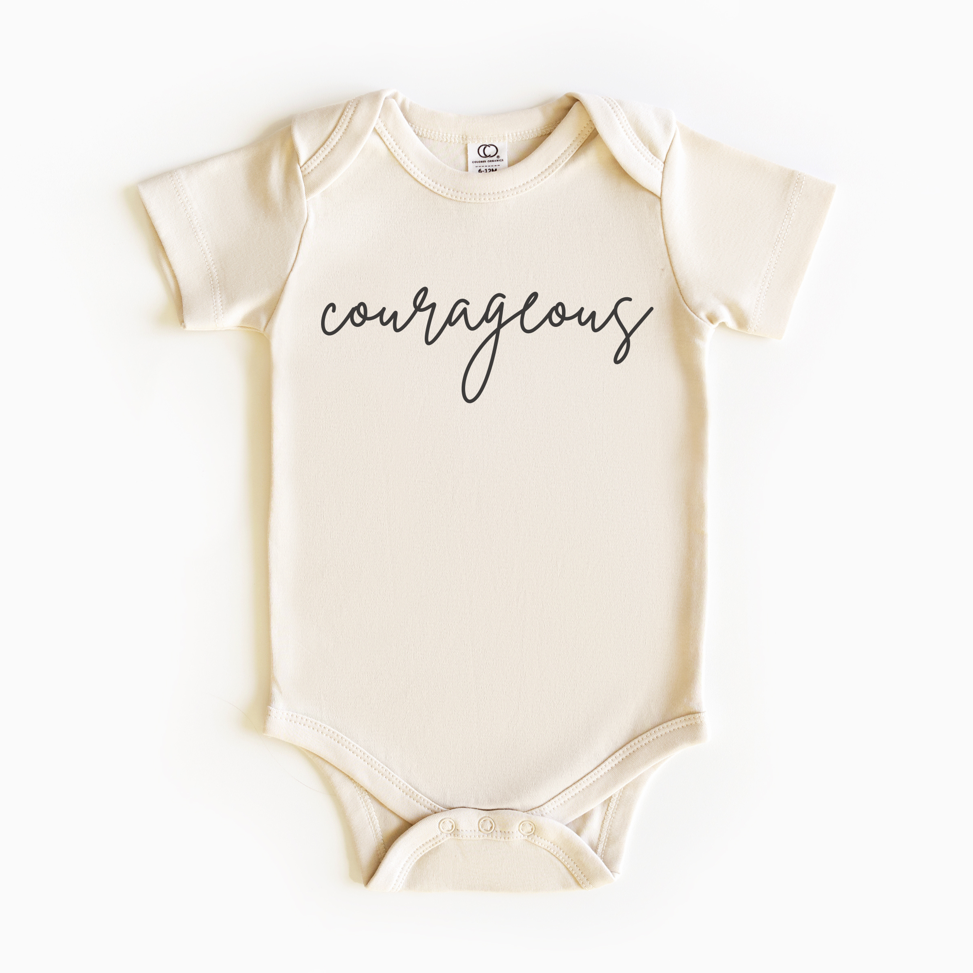 Baby wearing “Courageous” affirmation bodysuit – Christian script design organic cotton outfit by Lumiere Vive
