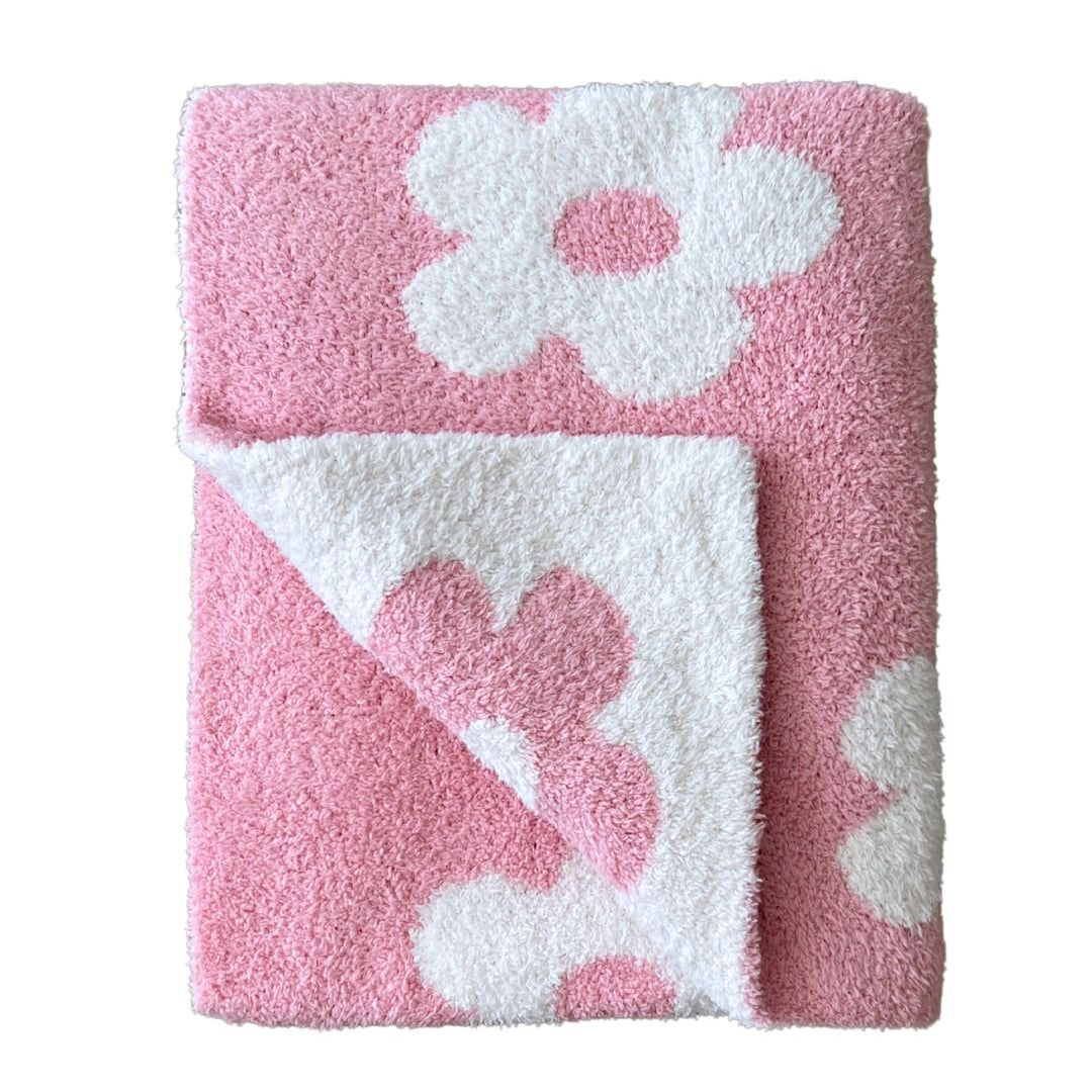 Pink and white floral-patterned towel on a white background
