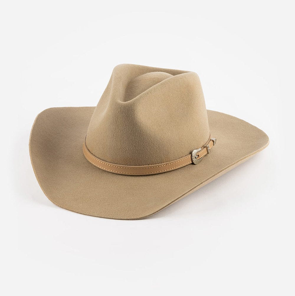 Tan cowboy hat with a band on a white background