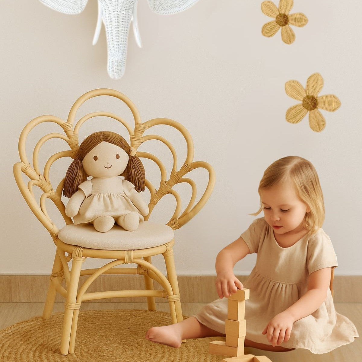 Child playing with a wooden toy in a room with a decorative elephant head and floral wall stickers.