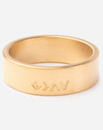 Gold ring with engraved design on a white background