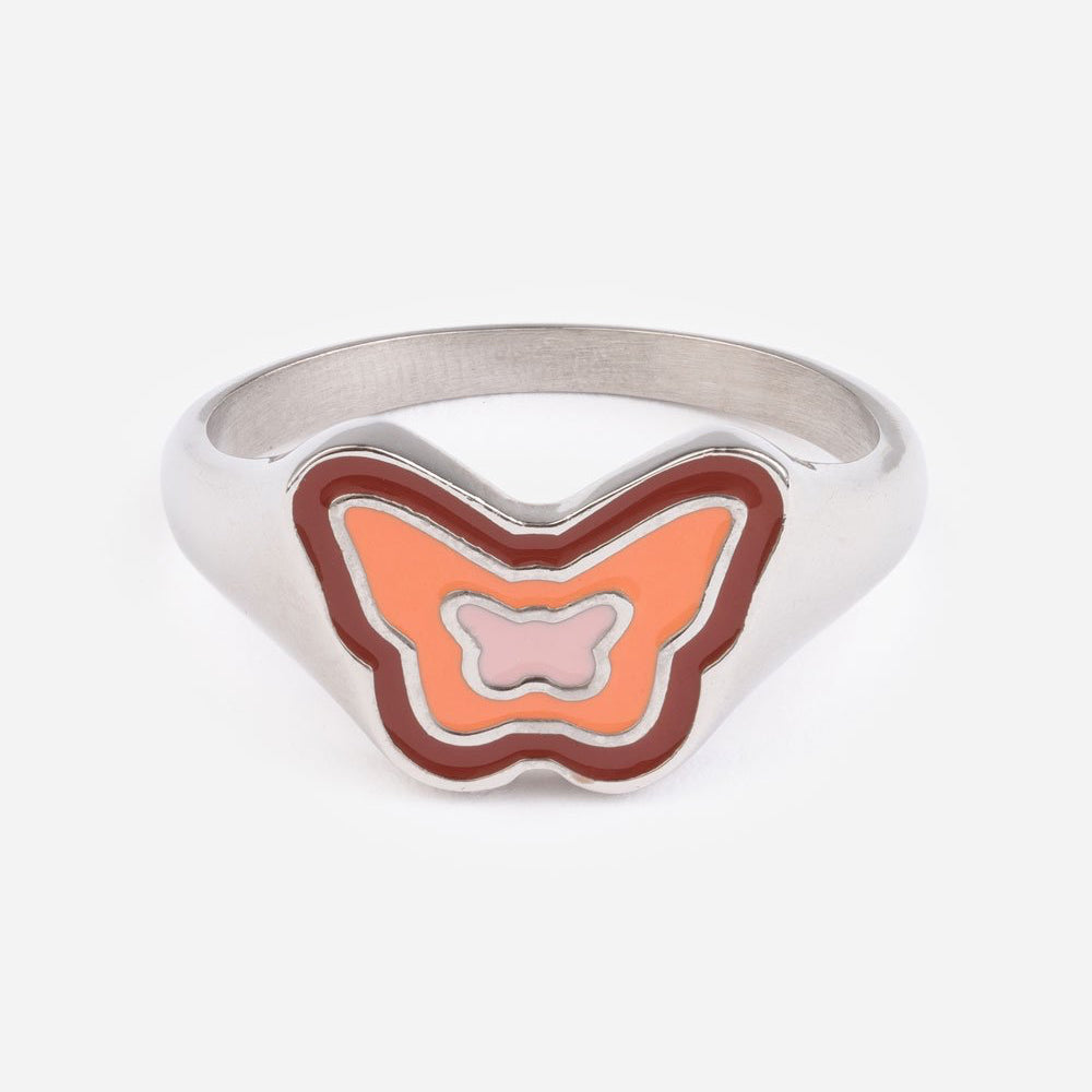 Butterfly-shaped ring with orange and pink design on a white background